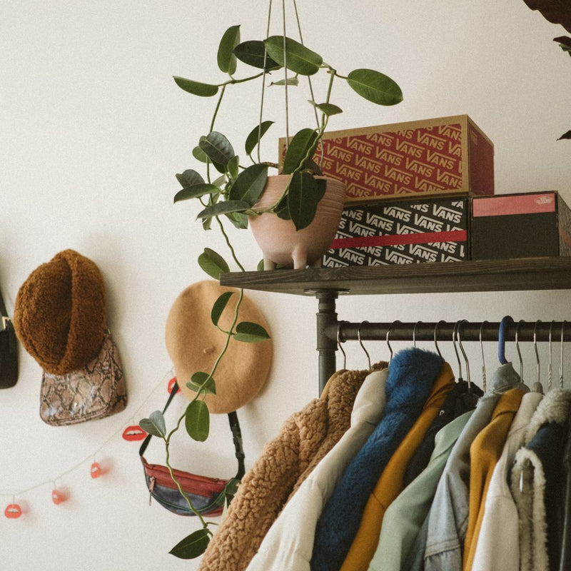 Clothing rail from dark water pipes with shelf on top for decoration and shoes