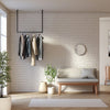 Ceiling mounted clothing rack for jackets in the entrance or waiting area made from black iron pipes