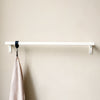 Modern simplistic wall mounted clothing rail made from iron pipes powder coated in white